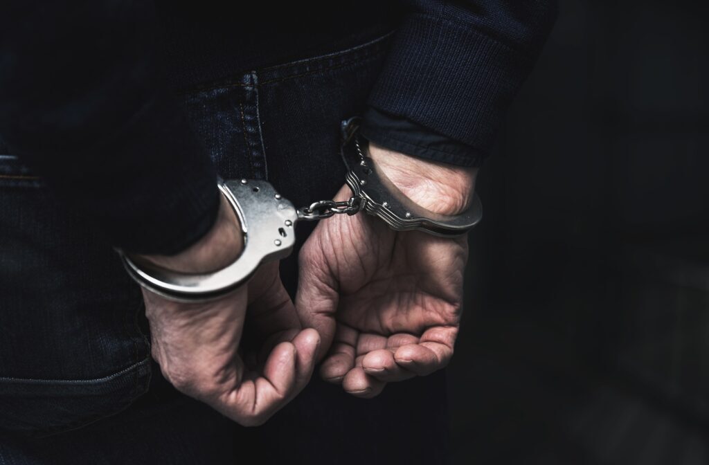 handcuffed arrested man - Surety Bonds - Air Capital Bail Bonds