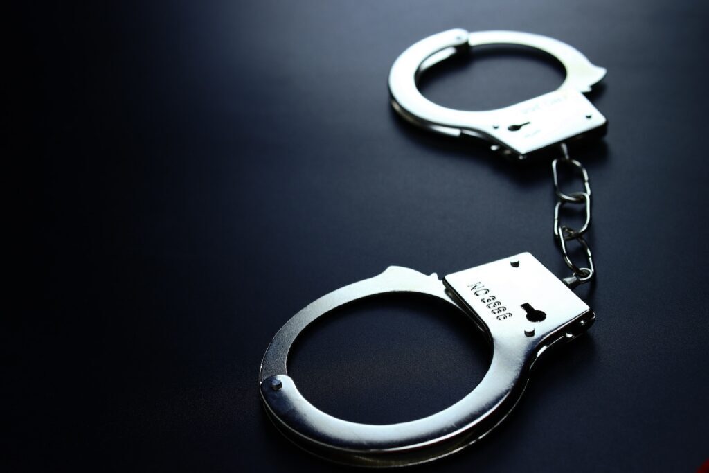 handcuffs on table - How Does A Surety Bond Work - Air Capital Bail Bonds