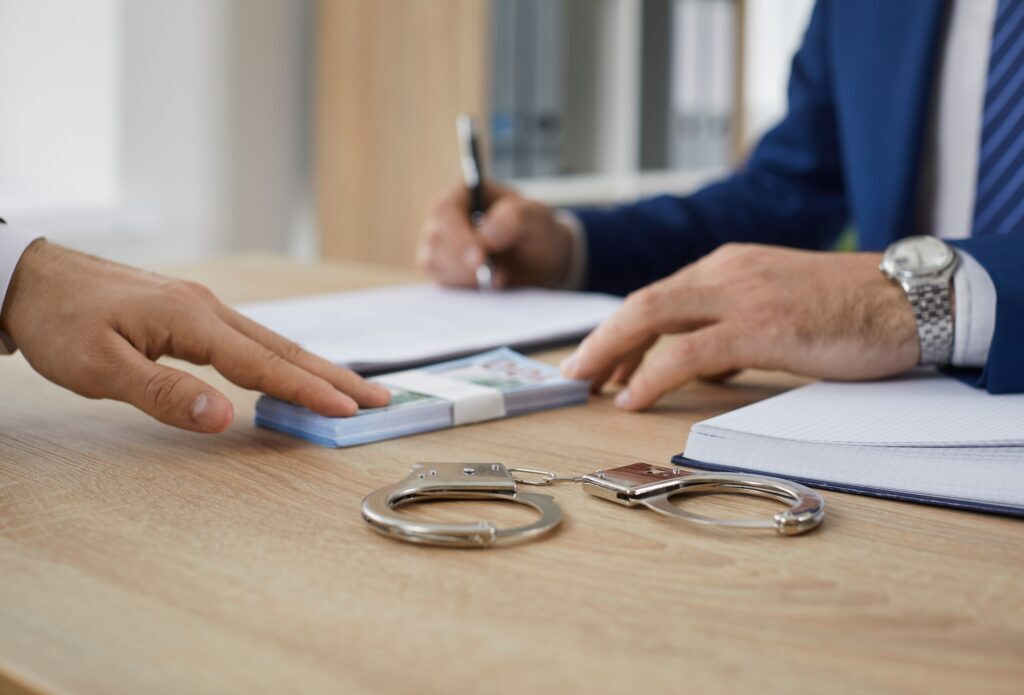 Man gives some money to a bondsman -Personal Recognizance Bond - Air Capital Bail Bonds