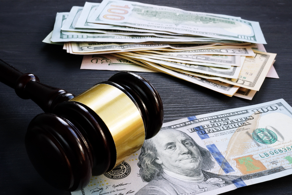 Bail bond and financial penalty. Gavel and money. Air Capital Bail Bonds is available 24/7 for assistance