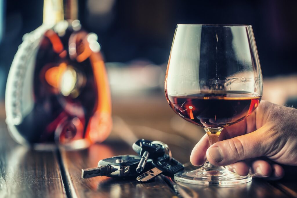 man with drink at bar and car keys - Can You Bail Someone Out for a DUI - Air Capital Bail Bonds